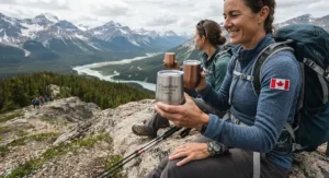 Shatterproof travel stemless wine glasses for camping held by a hiker taking a break during a scenic Canadian adventure.