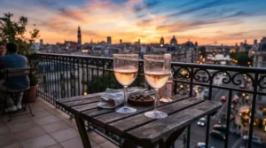 A durable acrylic wine glasses set on a downtown apartment balcony overlooking the city skyline.