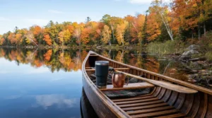 Stainless steel wine tumblers showcasing reliable temperature retention sitting safely inside a canoe on a calm lake.